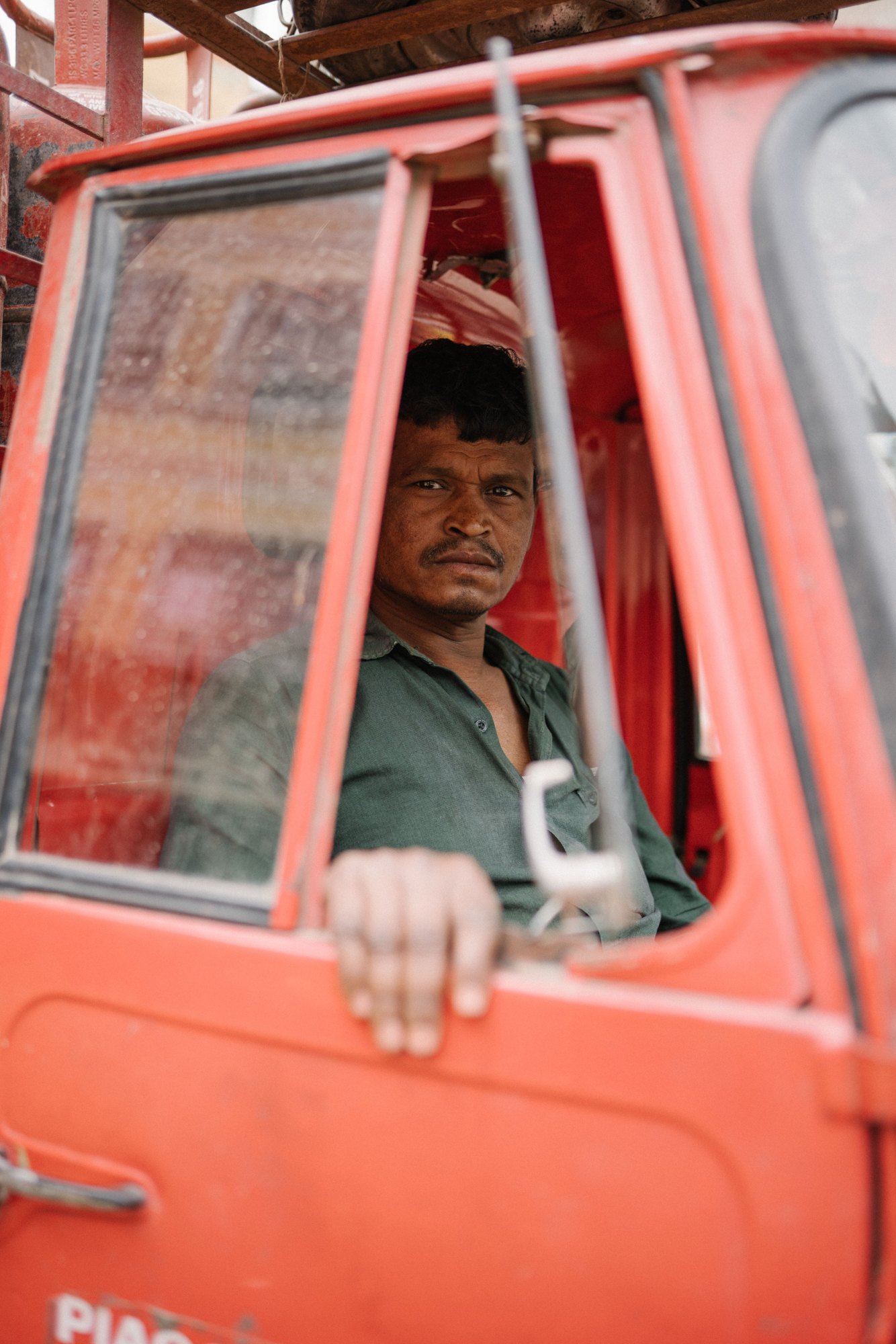 A driver standing at the door of his truck