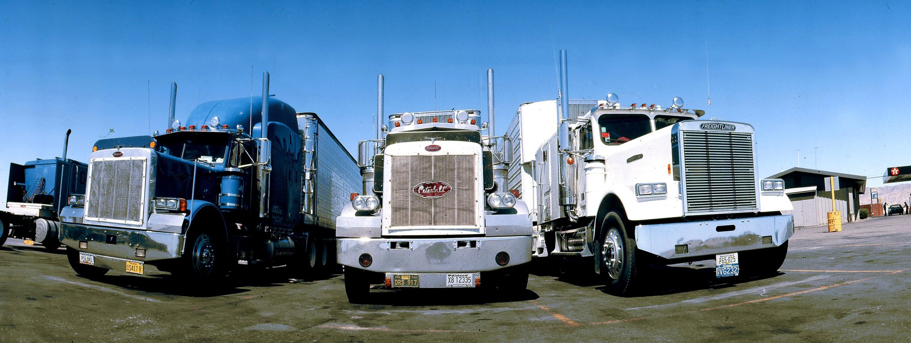 Three tractor units lined up at a freight yard